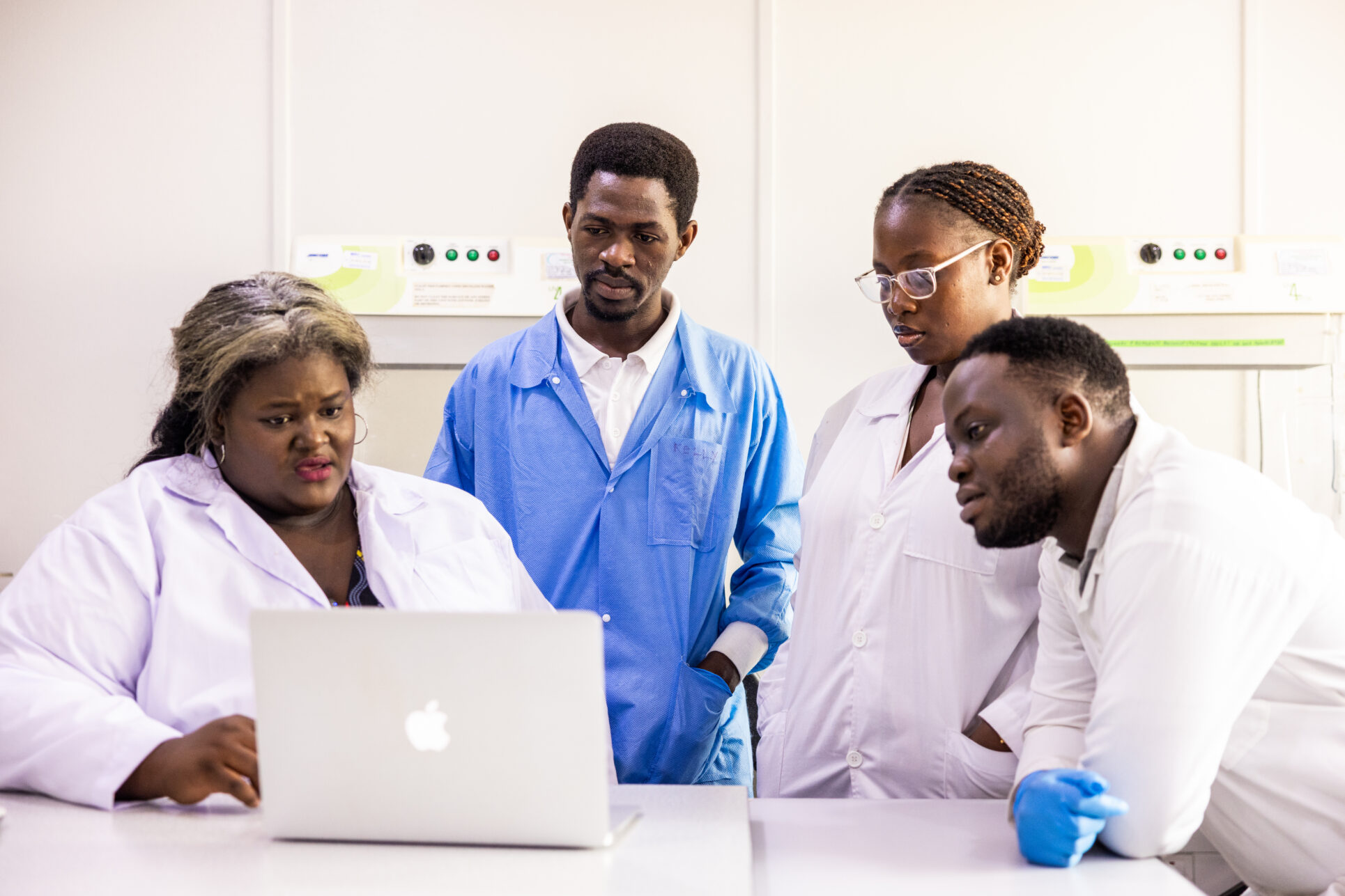 Krystal Mwesiga Birungi, an entomologist with Target Malaria Uganda, reviews research data on malaria-transmitting mosquitoes with laboratory technologists at the Uganda Virus Research Institute in Entebbe, Uganda on September 5, 2025.