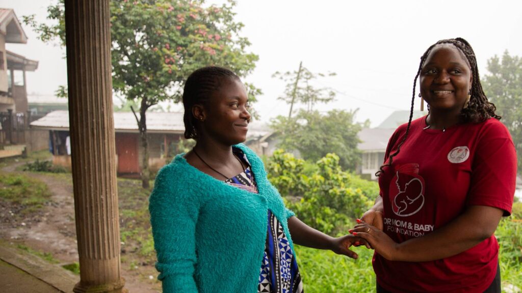 Photo: Pregnant woman smiling with Ashu Martha Agbornyenty, Changemaker Award winner